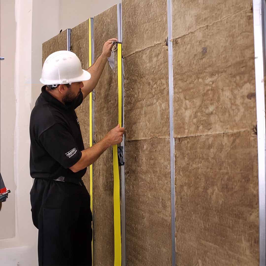 Photo of a man using DANOSA FONODAN 50mm Tape - 1000cm x 4.6cm in the appropriate application