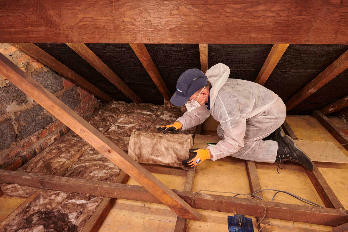 Person installing Knauf Loft Roll 44