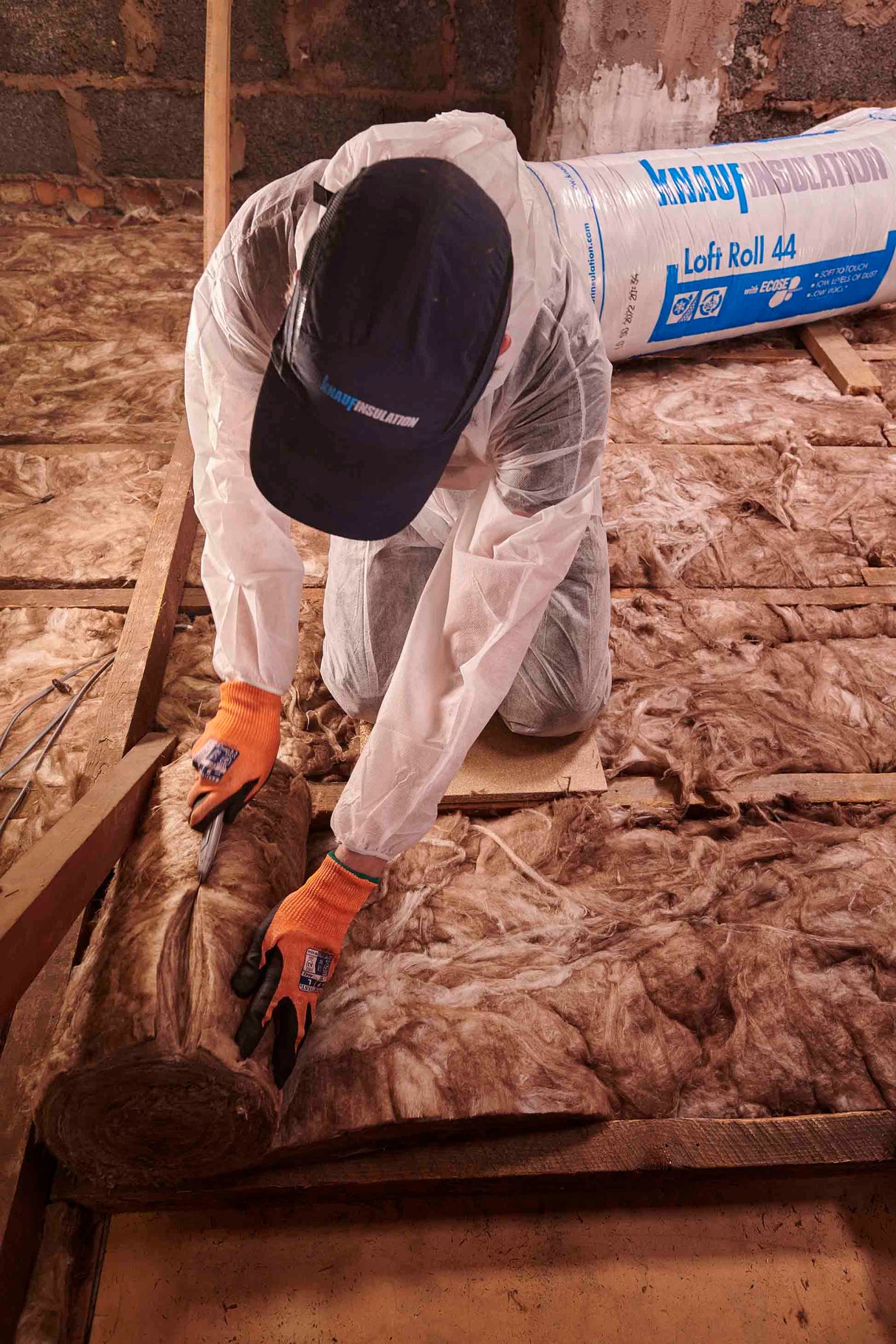 Person installing Knauf Loft Roll 44