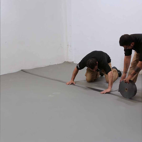 Two men installing the Danosa overlap tape